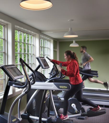 A woman and a man exercising in a fitness center