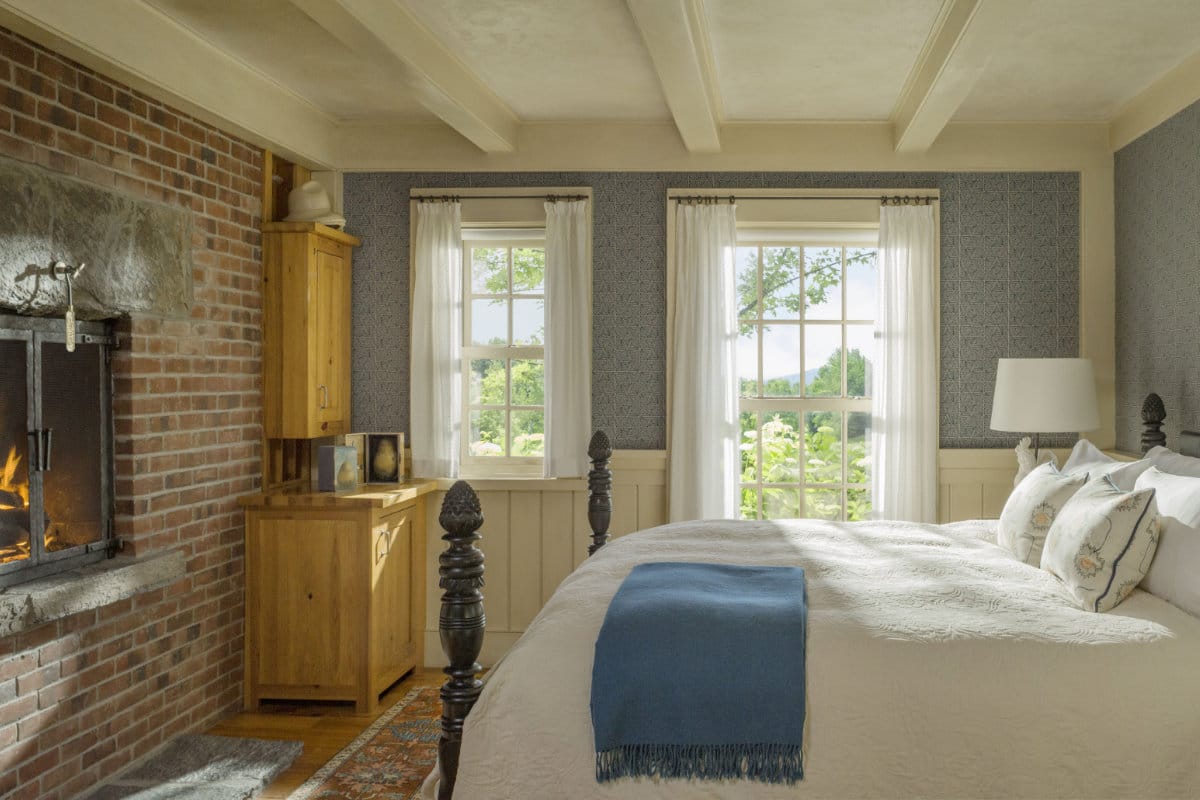 Lilac bedroom with bed and fireplace