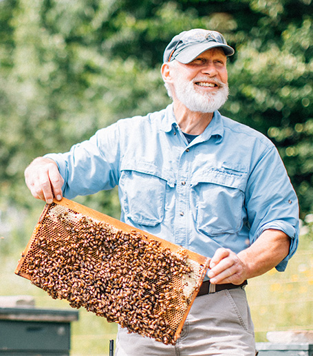 A man holding bee hive.