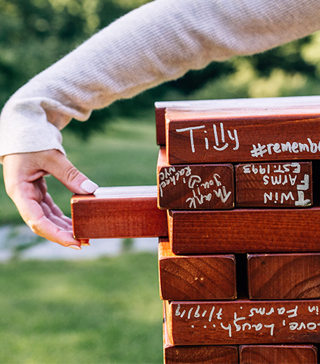 A person removing a piece from a Jenga game