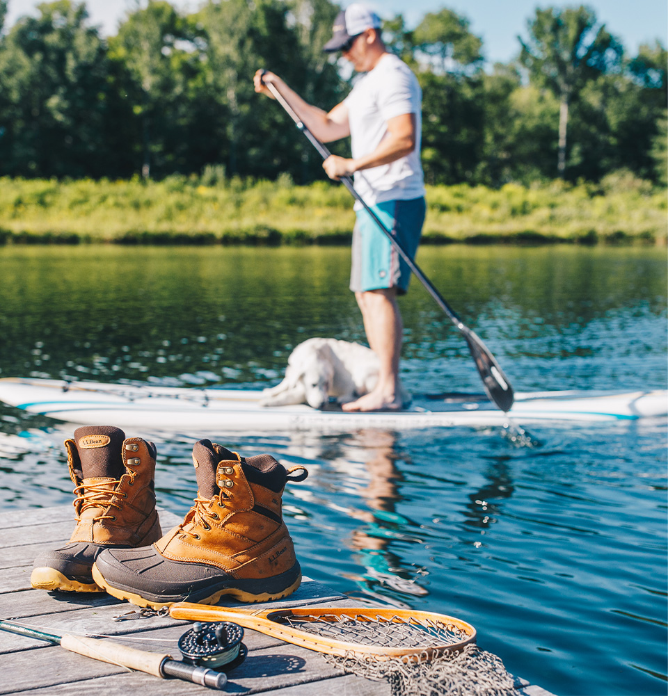 Man kayaking with a dog