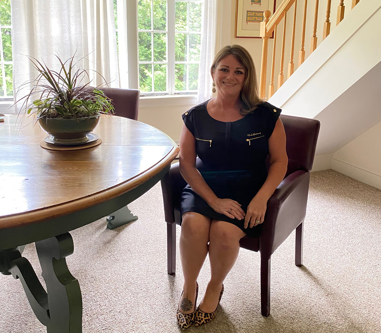 employee sitting on a chair smiling