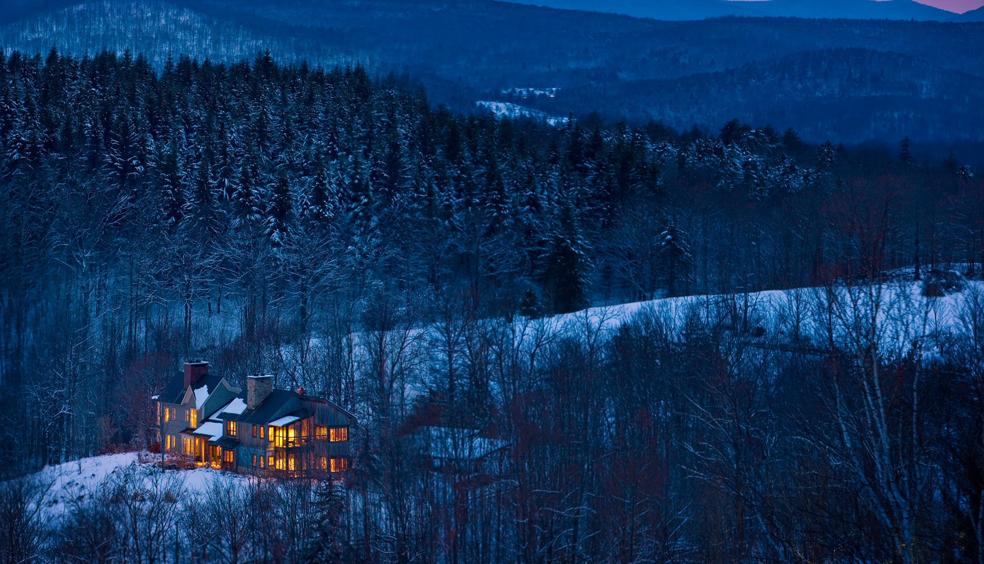 two cyclists a male and a female cycling on a dirt road with lush green surroundings
